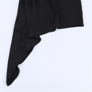 Vue détaillée de l'ourlet asymétrique et des coutures précises sur la robe noire chic