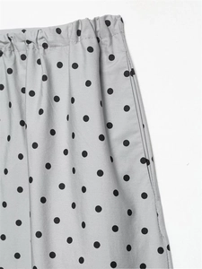 Detail of grey polka dot skirt showing elastic pleated waist and side pocket