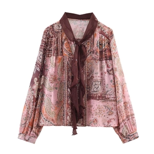Detail of bohemian pink paisley print chiffon blouse with bow tie and elastic cuffs