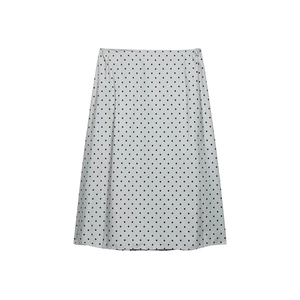 Minimalist white polka dot midi skirt with black spots and elastic waist flat lay