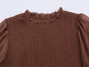 Detail of smocking texture and ruffle collar on a brown French style vintage top