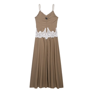 Detail of brown striped maxi dress featuring white lace trim and slim fit bodice