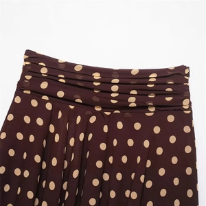 Brown polka dot skirt featuring layered waist pleats and detailed accordion folds