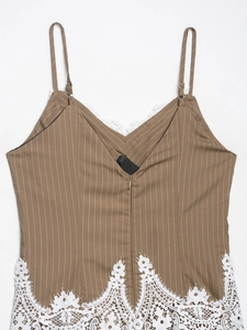 Detail of brown pinstripe camisole featuring white lace trim and front zipper closure
