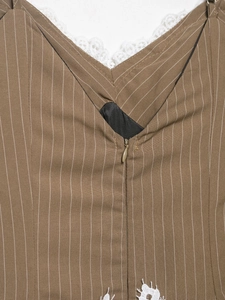 Detail of brown striped dress featuring white lace trim and a hidden zipper closure
