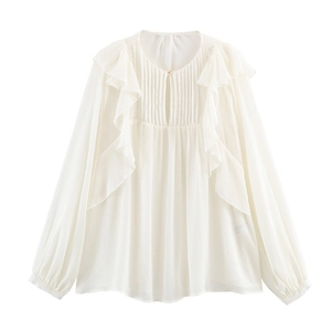 Close-up of cream white chiffon shirt featuring pleated ruffles and lantern sleeves