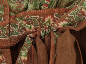Macro detail of bohemian paisley print fabric with adjustable drawstring waist tie