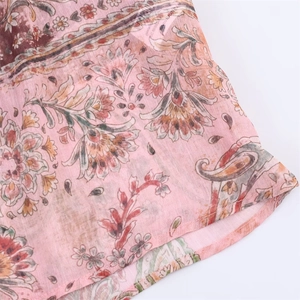 Close-up of pink chiffon fabric with vintage floral and paisley print patterns