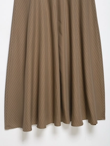Detail of brown pinstriped A-line skirt fabric with elegant vertical stripes and pleated hem