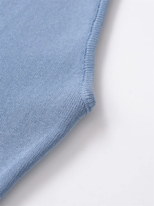 Detailed close-up showing precise seam craftsmanship on light blue knit sweater sleeves