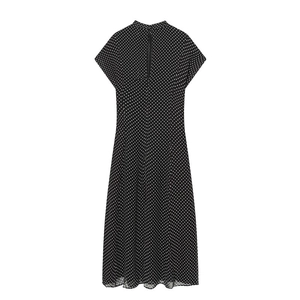 Detail of a black polka dot A-line dress featuring a back zipper and high neckline