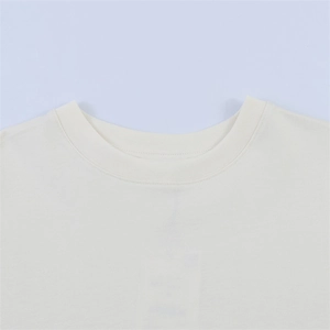 Detailed macro view of the cream crew neck t-shirt featuring ribbed collar and stitching