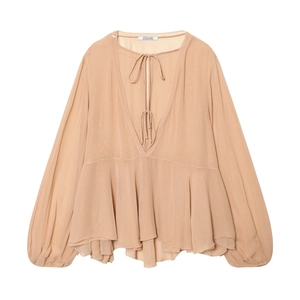 Detailed view of light brown deep V-neck blouse with thin ties and tiered ruffled hem