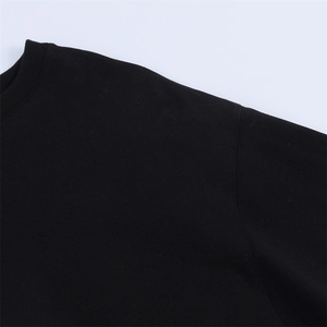 Close-up of black crewneck sweatshirt showing high-quality dropped shoulder stitching