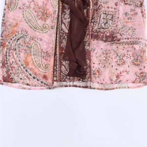 Pink paisley print chiffon shirt featuring brown ruffled hem and elegant floral pattern