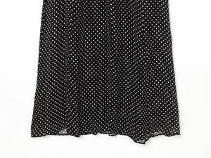 Detail of black and white polka dot chiffon dress hemline with high-quality stitching