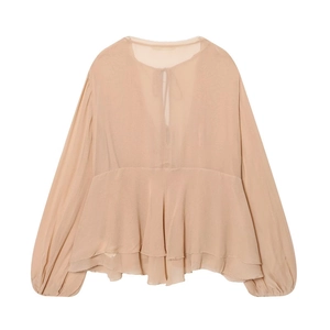 Detail of layered ruffle hem on apricot chiffon long sleeve shirt with v-neck tie