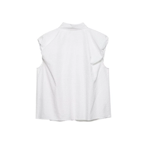 Detail of white sleeveless shirt with textured seersucker fabric and ruffled shoulders