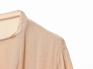 Detail shot of sheer chiffon fabric with precise stitching and subtle scalloped neck edge