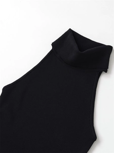 Detail of black ribbed knit turtleneck showing the close-up texture and high neck design