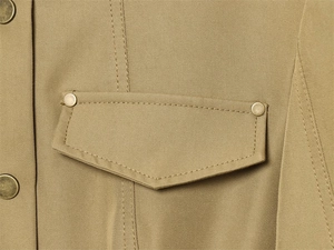 Close-up of khaki twill blazer featuring a unique flap pocket and antique copper button