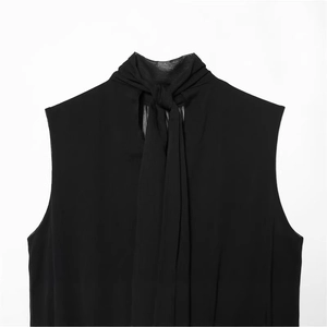 Elegant black sleeveless high-neck top with ribbon tie detail and balloon silhouette