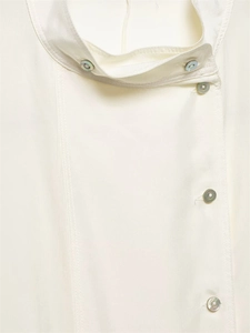 Detail of silk shirt showing elegant stand-up collar and pearl buttons on satin fabric