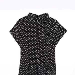 Elegant black and white polka dot short sleeve blouse with a bow tie high collar detail
