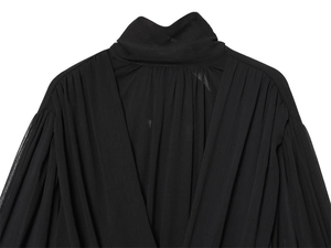 Close-up of black pleated chiffon shirt featuring elegant high collar and V-shaped drape detail