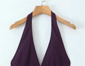 Detailed view of the deep purple halter neck design and silky fabric on this dress
