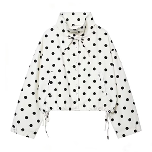Close-up of polka dot short jacket with black adjustable drawstrings and white buttons