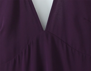 Macro view of the V-neckline stitching and premium dark purple chiffon fabric detail