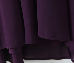 Close-up of deep purple dress hem showing fine chiffon texture and delicate stitching