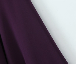 Close-up of deep purple fabric texture and weave for slim fit halter dress