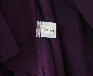 Detailed view of dark purple dress inner seams and For Love brand label size S
