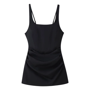 Detail of a black backless mini dress with slim straps, square neck, and ruched details