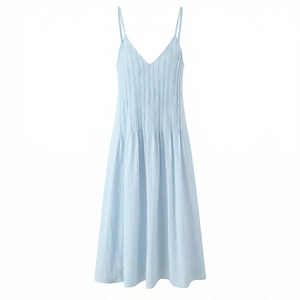 Detail of light blue summer dress featuring pintuck pleats and thin spaghetti straps