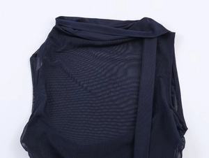 Detailed close-up of dark blue mesh fabric with delicate pleated halter neck design