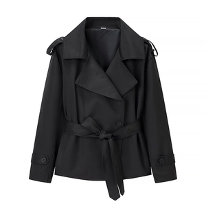 Detailed view of black short jacket featuring wide lapels, epaulettes, and belted waistline