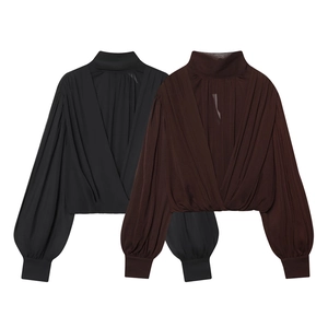 Women's pleated chiffon blouse featuring a mock neck and lantern sleeves in black and brown