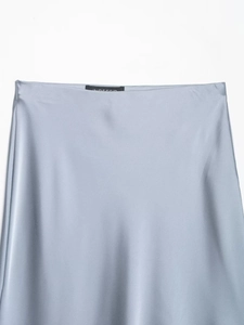 Detailed view of the smooth light blue satin skirt waist with elegant silk texture