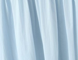 Macro shot of light blue pleated chiffon fabric texture for summer dress detail