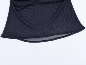 Detail of black semi-transparent mesh fabric with refined hemline stitching and texture