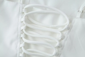 Detailed macro view of white lace-up criss-cross ties and adjustable shoulder straps