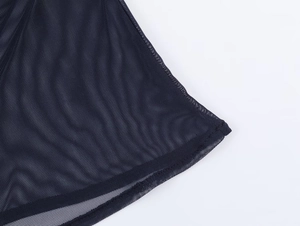 Detail of breathable mesh fabric texture and high-quality hem stitching on slim-fit top