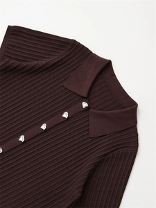 Close-up of brown ribbed knit polo top featuring silver unique metal buttons detailing