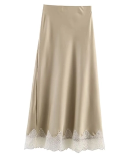 Detail of champagne satin midi skirt showing delicate white lace hemline and silky texture