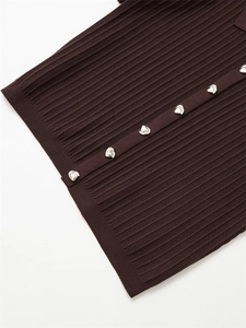 Macro detail of dark brown ribbed knit top featuring unique silver irregular metal buttons