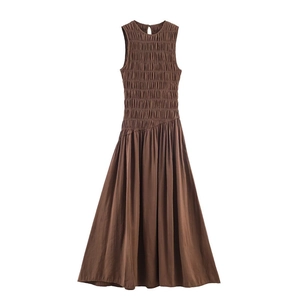 Detail of smocked texture on a dark brown sleeveless midi dress with elastic pleats