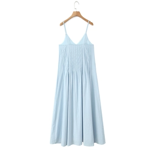 Detail of light blue slip dress with pleated V-neck and fine adjustable spaghetti straps